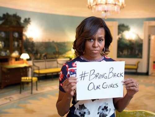 Michelle Obama holds a sign saying #BringBackOurGirls