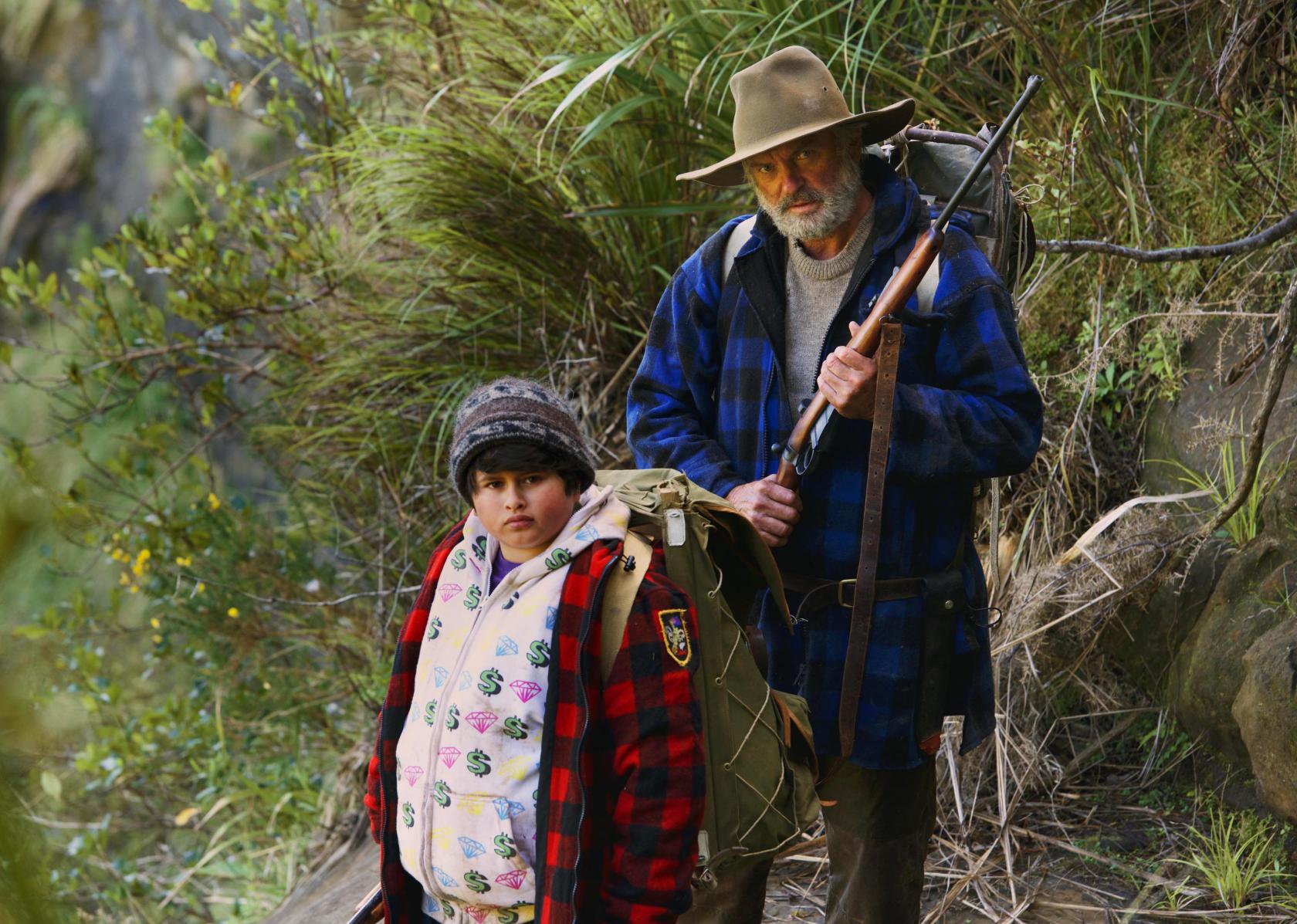 This image released by The Orchard shows Julian Dennison, left, and Sam Neill in a scene from "Hunt For The Wilderpeople." (The Orchard via AP)